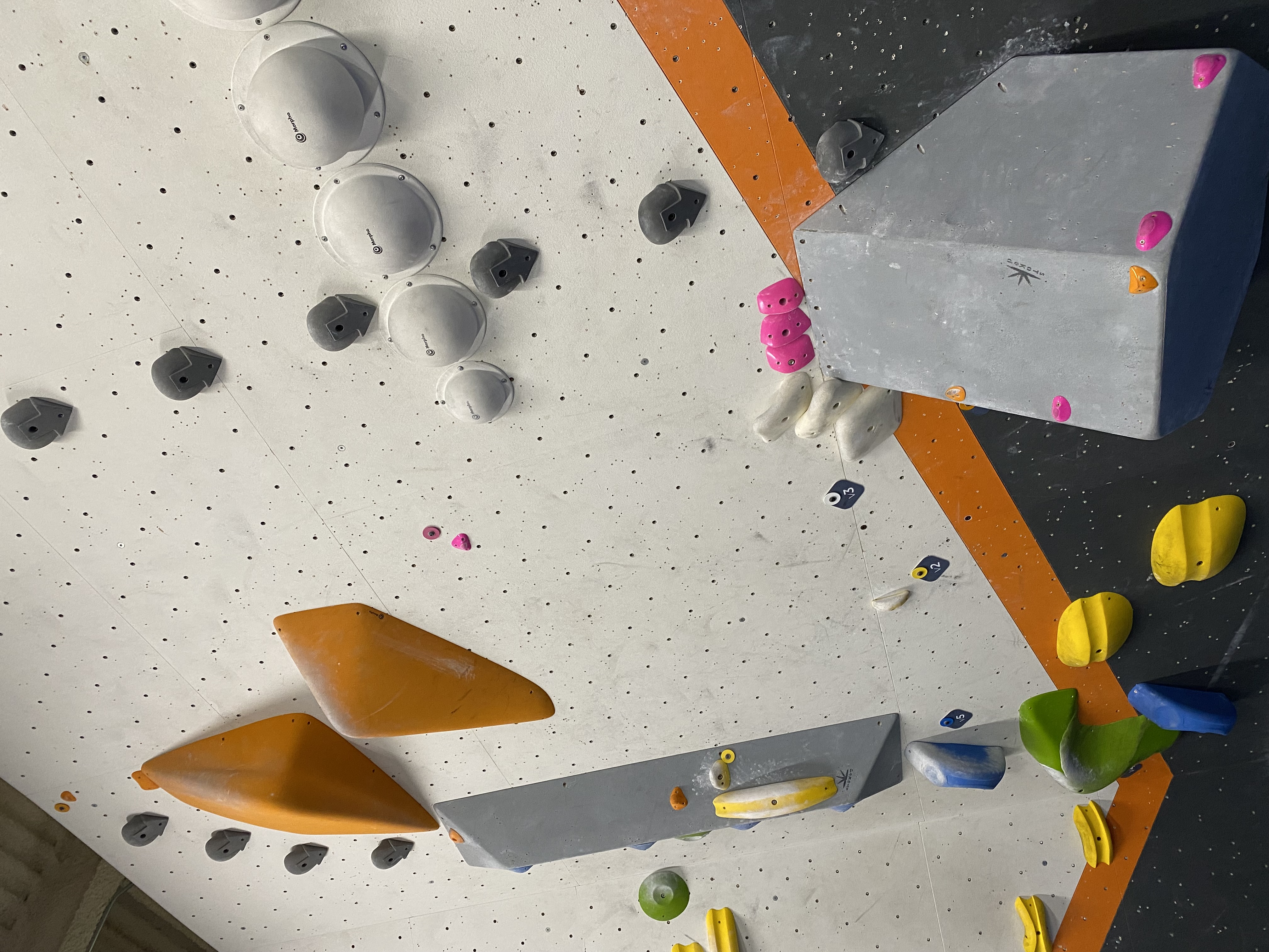 a bouldering route that starts on a volume with small footholds you have to leap from, into a slightly awkward finish